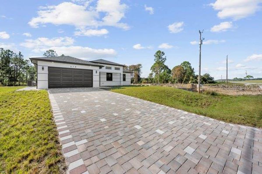 Front exterior of a new home in , Lehigh Acres, FL, highlighting curb appeal (Image 24). Front exterior of a new home in , Lehigh Acres, FL, highlighting curb appeal (Image 24).