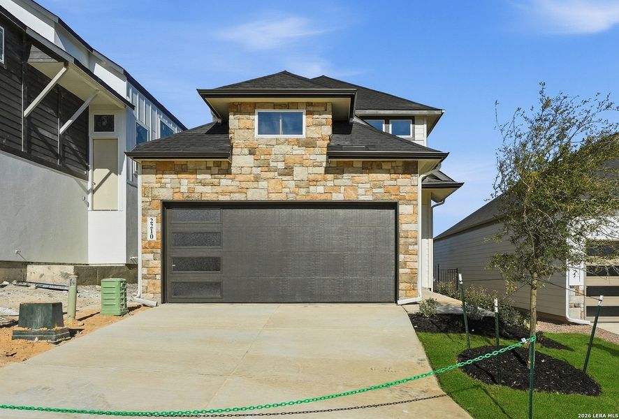 Front exterior of a new home in Prominence, San Antonio, TX, highlighting curb appeal (Image 22).