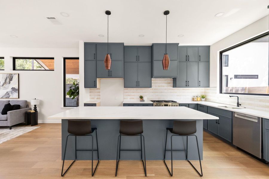 Culinary dreams come alive in this kitchen with an expansive island and top-tier appliances.