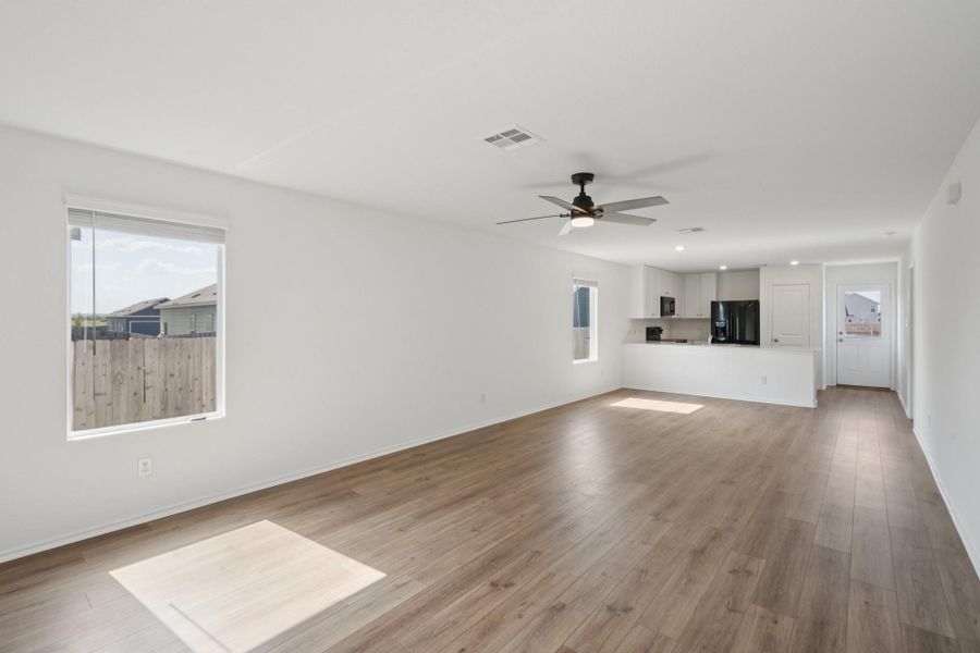 Natural light bathes this open-concept living space, highlighting the beautiful wood flooring and modern kitchen. Natural light bathes this open-concept living space, highlighting the beautiful wood flooring and modern kitchen.