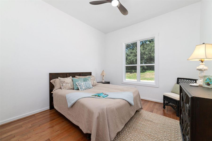 Cozy secondary bedroom also features the same hardwood flooring and ceiling fan. Cozy secondary bedroom also features the same hardwood flooring and ceiling fan.