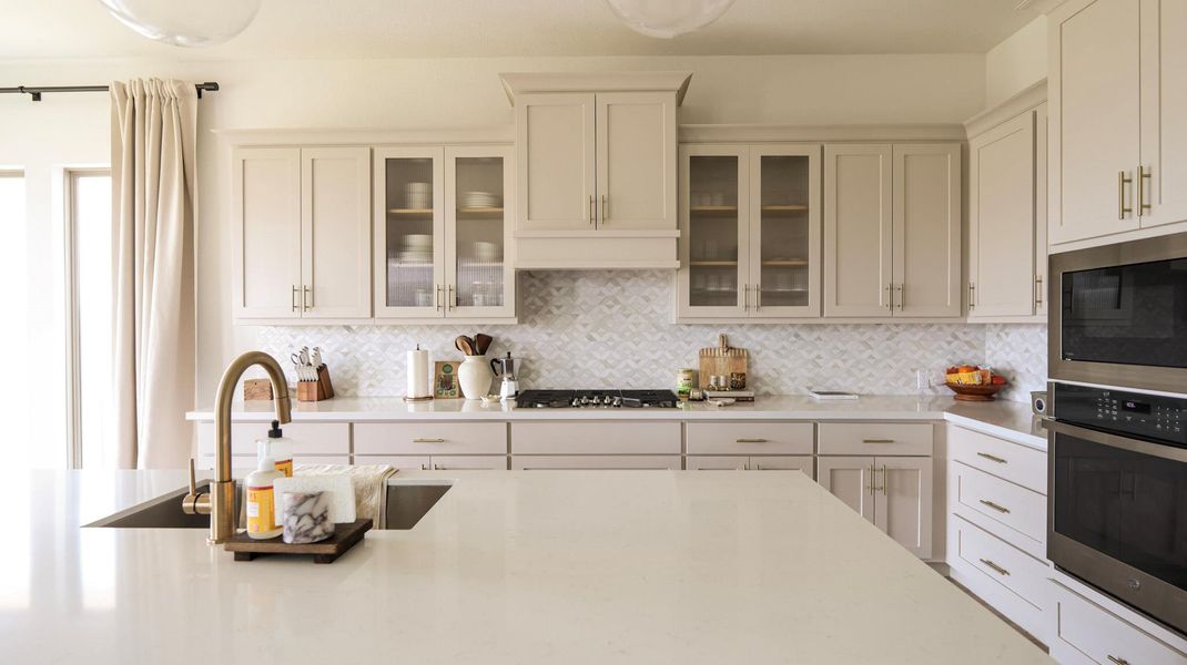 A well-appointed kitchen showcasing elegant cabinetry and a practical island, perfect for culinary endeavors. A well-appointed kitchen showcasing elegant cabinetry and a practical island, perfect for culinary endeavors.