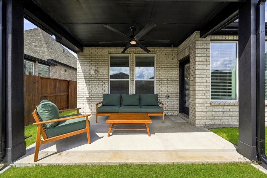 The covered back patio offers a comfortable extension of the home, complete with a ceiling fan with integrated light for relaxing outdoors in any season. The covered back patio offers a comfortable extension of the home, complete with a ceiling fan with integrated light for relaxing outdoors in any season.