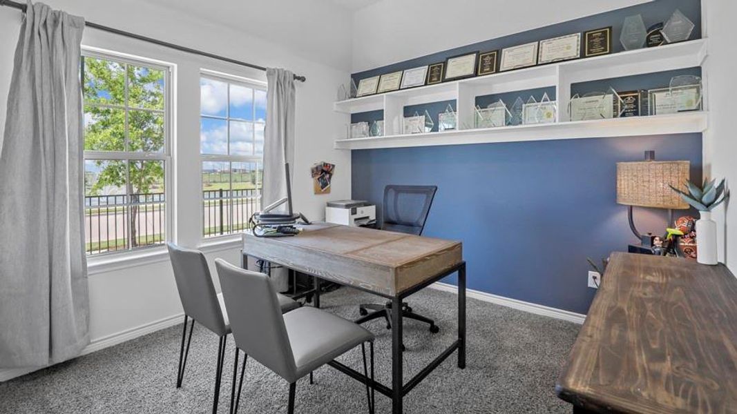 Carpeted office space featuring baseboards