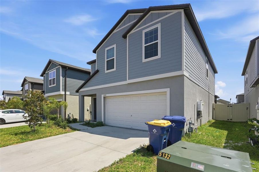 Front exterior of a new home in Connerton, Land O' Lakes, FL, highlighting curb appeal (Image 2). Front exterior of a new home in Connerton, Land O' Lakes, FL, highlighting curb appeal (Image 2).