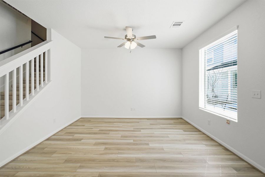 Empty room featuring ceiling fan and light wood-style floors Empty room featuring ceiling fan and light wood-style floors