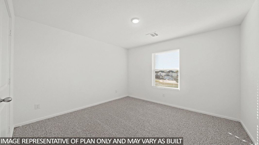 Bright room featuring neutral-toned carpet and white walls