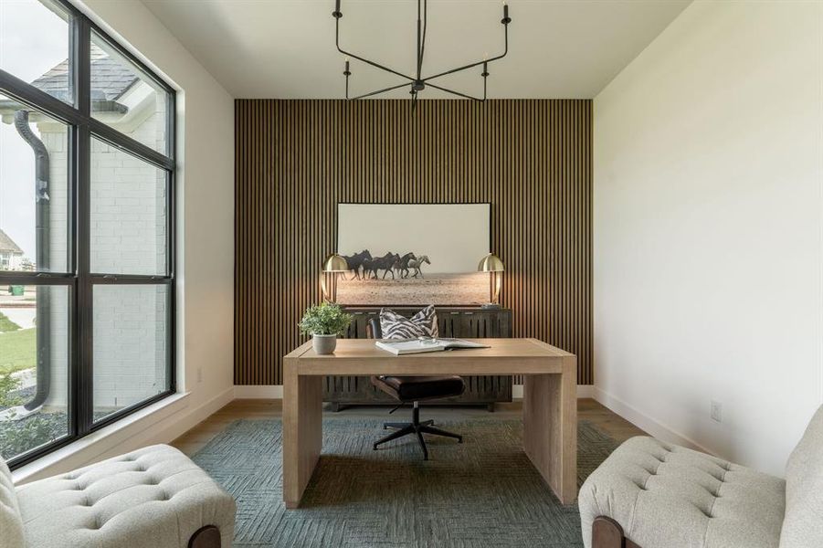 Home office with wood finished floors, an accent wall, and radiator heating unit Home office with wood finished floors, an accent wall, and radiator heating unit