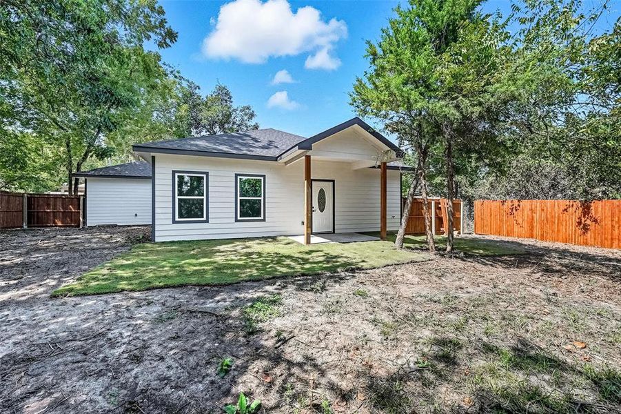 Rear view of property featuring a patio, a fenced backyard, and a shingled roof Rear view of property featuring a patio, a fenced backyard, and a shingled roof