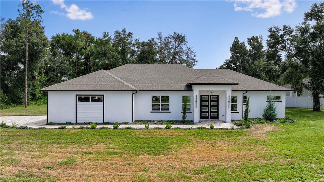 Front exterior of a new home in , Leesburg, FL, highlighting curb appeal (Image 25).
