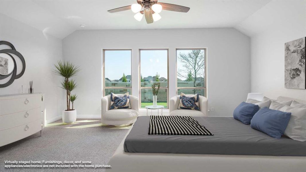 Carpeted bedroom with lofted ceiling and ceiling fan