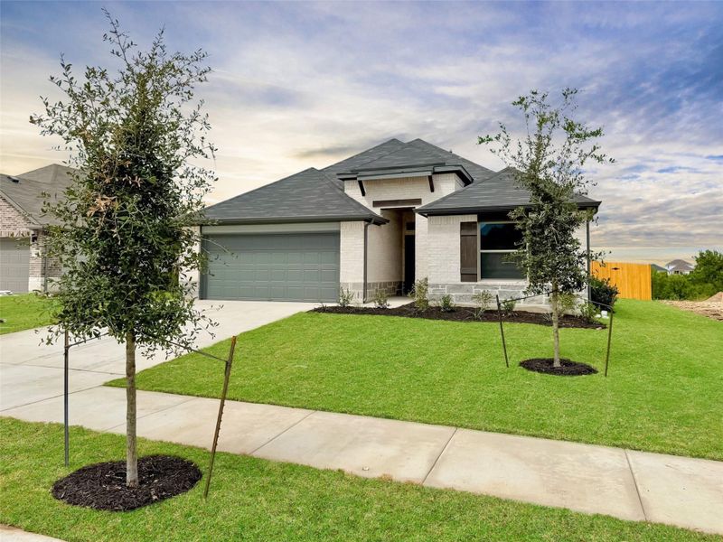 Front exterior of a new home in Prairie Winds, Hutto, TX, highlighting curb appeal (Image 2). Front exterior of a new home in Prairie Winds, Hutto, TX, highlighting curb appeal (Image 2).