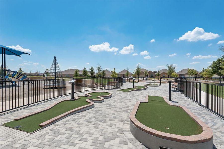 View of home's community with an area to practice putting and a residential view View of home's community with an area to practice putting and a residential view