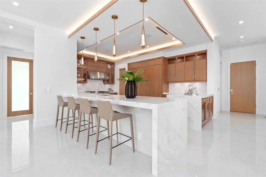 The gourmet kitchen is a chef’s dream, featuring marble countertops, real wood cabinetry,