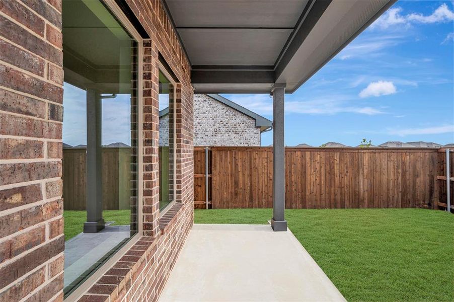 Fenced backyard featuring a patio area Fenced backyard featuring a patio area