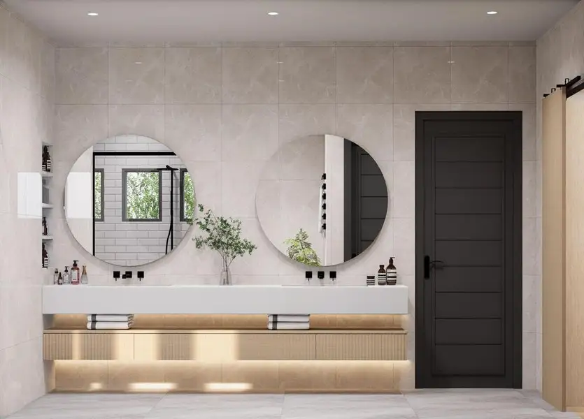 Bathroom featuring double vanity and tile walls