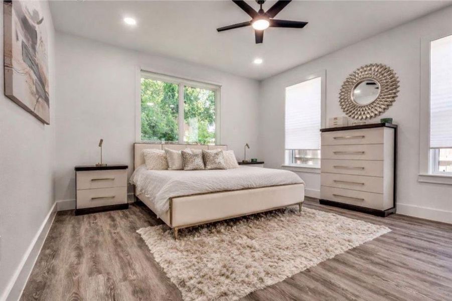 Bedroom featuring wood finished floors, multiple windows, recessed lighting, and ceiling fan