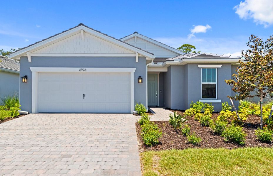 Front exterior of a new home in Legacy Groves, Nokomis, FL, highlighting curb appeal (Image 1). Front exterior of a new home in Legacy Groves, Nokomis, FL, highlighting curb appeal (Image 1).