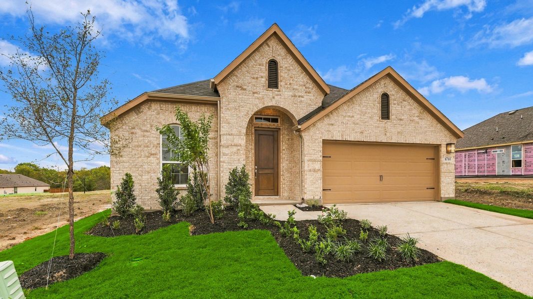 Front exterior of a new home in Thompson Farms, Van Alstyne, TX, highlighting curb appeal (Image 22). Front exterior of a new home in Thompson Farms, Van Alstyne, TX, highlighting curb appeal (Image 22).