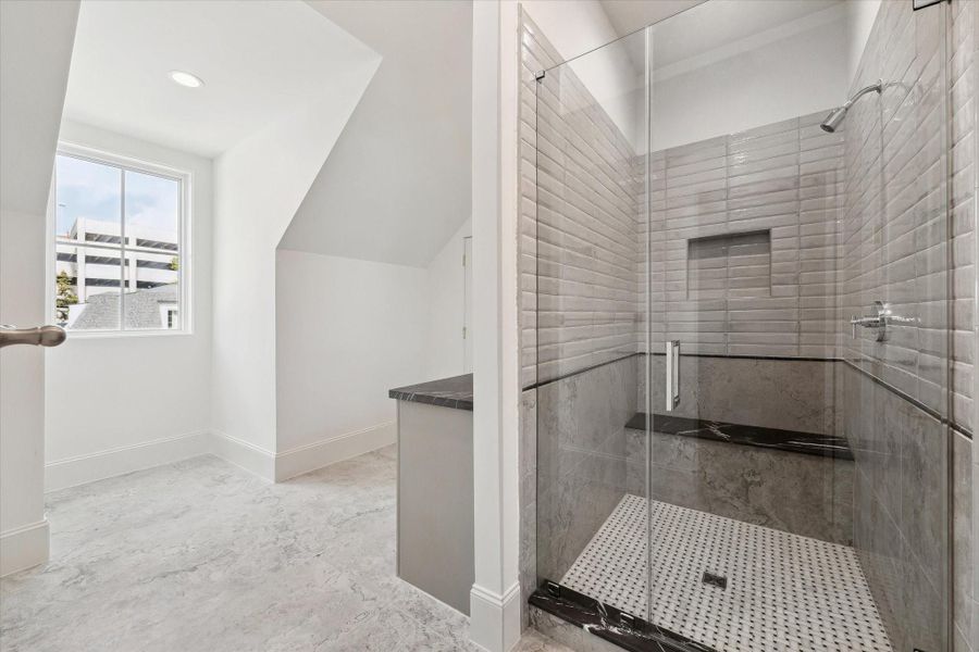 Hollywood bath on the third floor with large counter space, glass-encased shower, and walk-in closet.