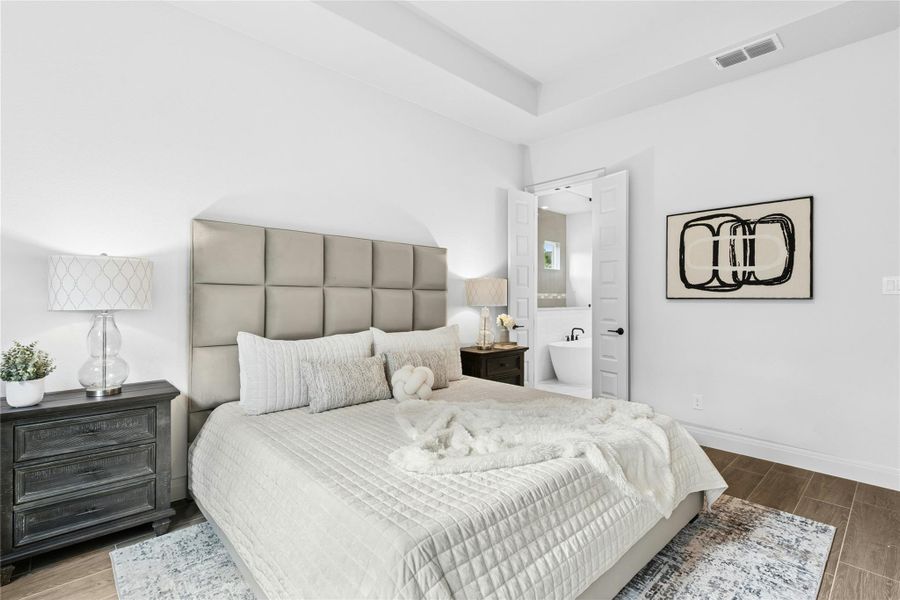 Bedroom with wood finish floors and ensuite bath Bedroom with wood finish floors and ensuite bath