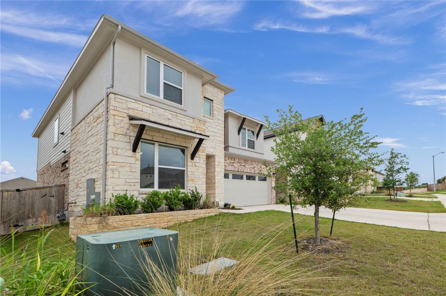 Front exterior of a new home in University Heights, Round Rock, TX, highlighting curb appeal (Image 21).