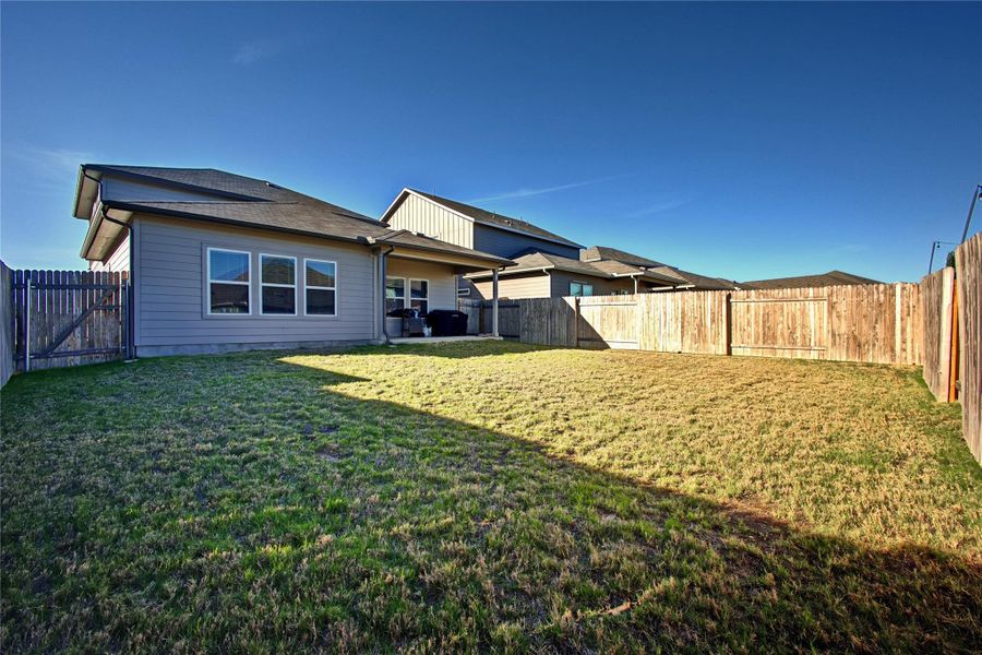 Back of property with a fenced backyard and a patio Back of property with a fenced backyard and a patio