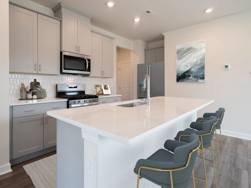 Kitchen in the Roswell floorplan at a Meritage Homes community in Garner, NC.