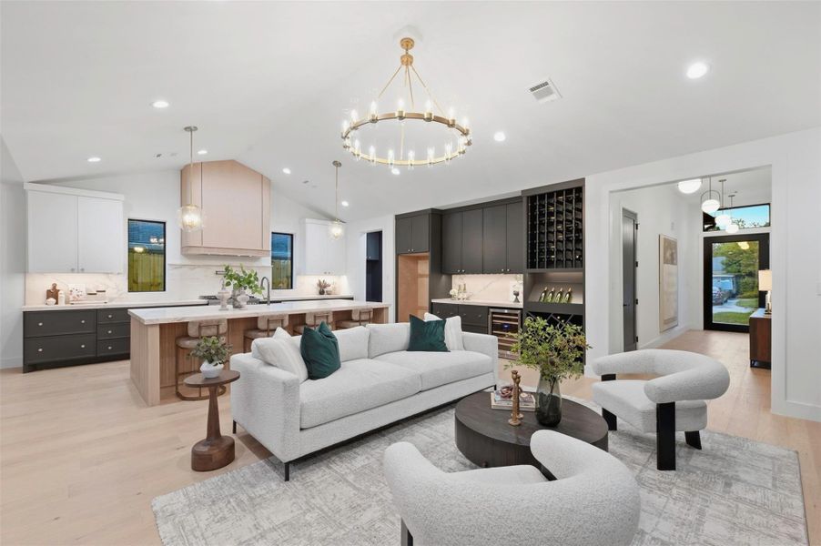 Imagine hosting the holidays in this inviting living space, with its soaring pitched ceiling, statement fireplace, and seamless flow into the kitchen—perfect for gathering, entertaining, and making memories all year long.