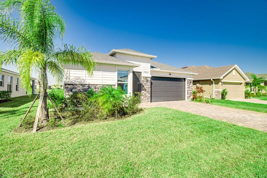 Front exterior of a new home in , Palm Bay, FL, highlighting curb appeal (Image 25).