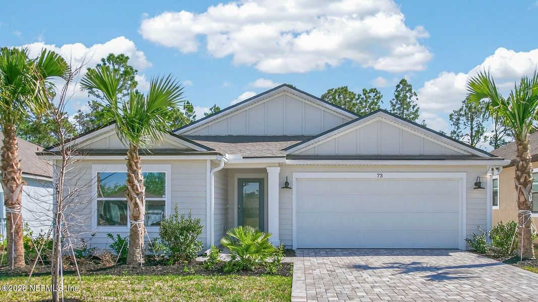 Front exterior of a new home in American Village, Palm Coast, FL, highlighting curb appeal (Image 22).