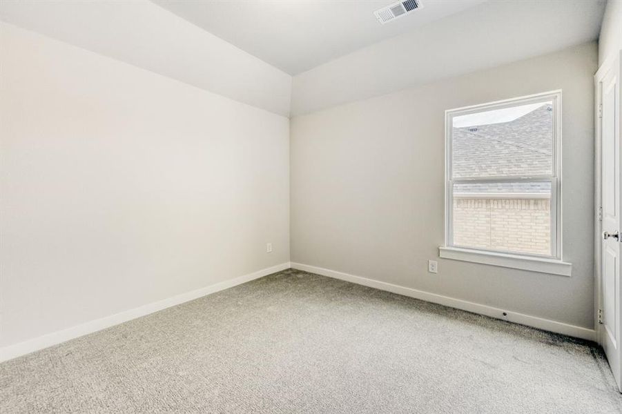 Carpeted spare room with baseboards