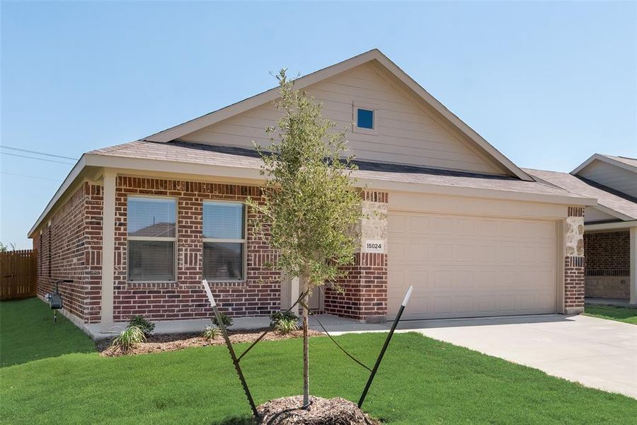 View of front of property featuring a front yard and a garage