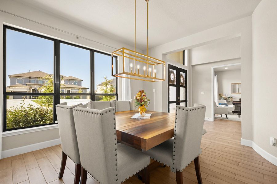 Dining area with light wood-style floors, a chandelier, french doors, and a residential view Dining area with light wood-style floors, a chandelier, french doors, and a residential view