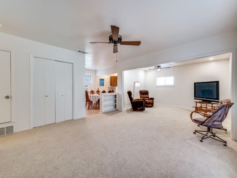 Living area featuring a ceiling fan and light carpet Living area featuring a ceiling fan and light carpet