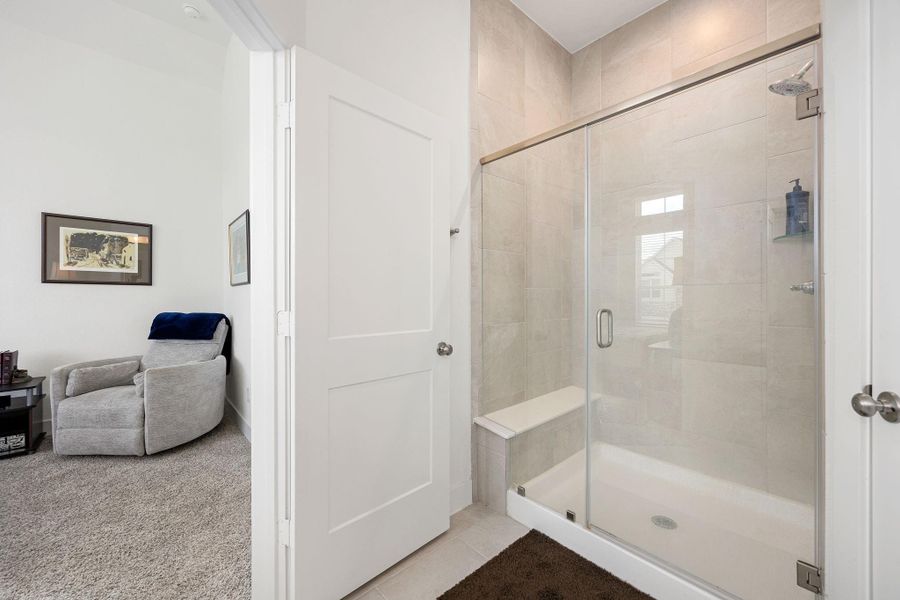 Primary walk in shower with bench seat
