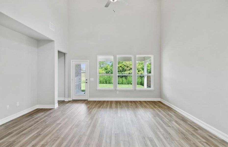 Spacious gathering room with large windows *real home pictured