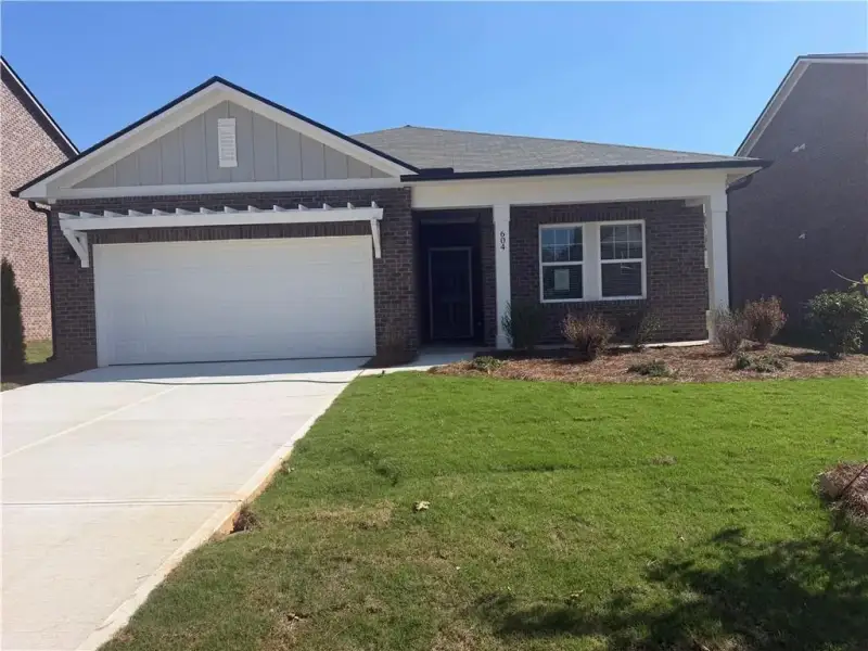 Front exterior of a new home in Kendall Grove, McDonough, GA, highlighting curb appeal (Image 1). Front exterior of a new home in Kendall Grove, McDonough, GA, highlighting curb appeal (Image 1).