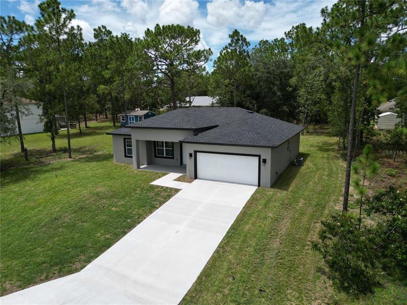 Front exterior of a new home in , Citrus Springs, FL, highlighting curb appeal (Image 24).
