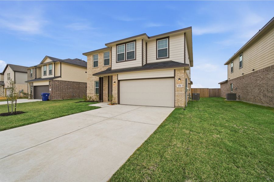 Front exterior of a new home in Pearlbrook, Texas City, TX, highlighting curb appeal (Image 2).
