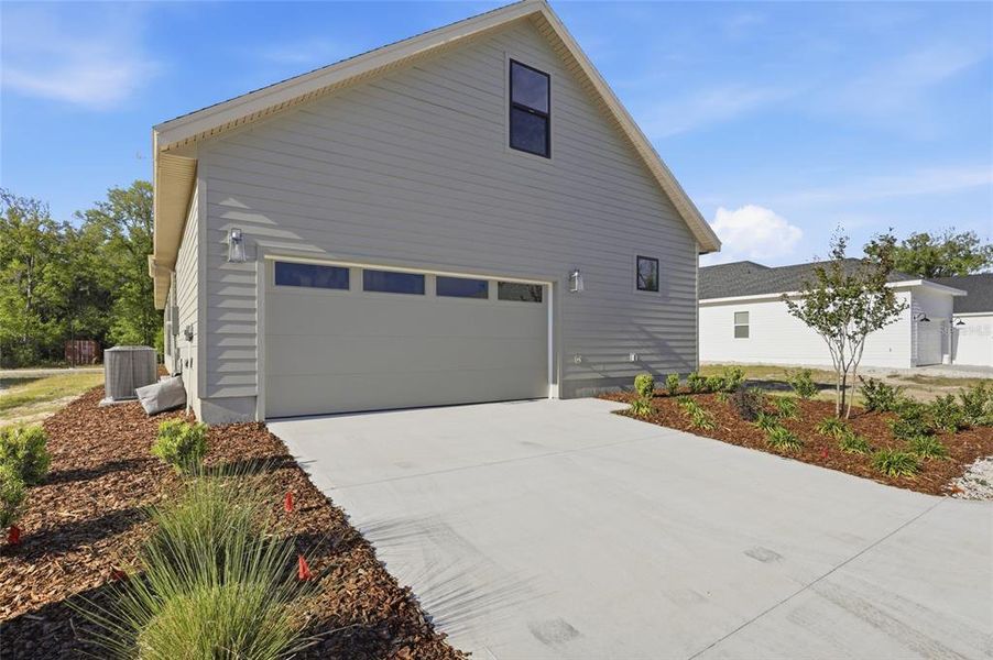 Front exterior of a new home in , Newberry, FL, highlighting curb appeal (Image 27).
