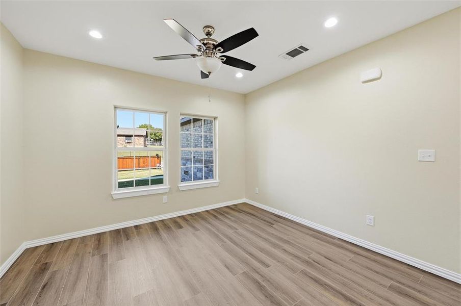 Empty room with light wood finished floors, recessed lighting, and a ceiling fan Empty room with light wood finished floors, recessed lighting, and a ceiling fan