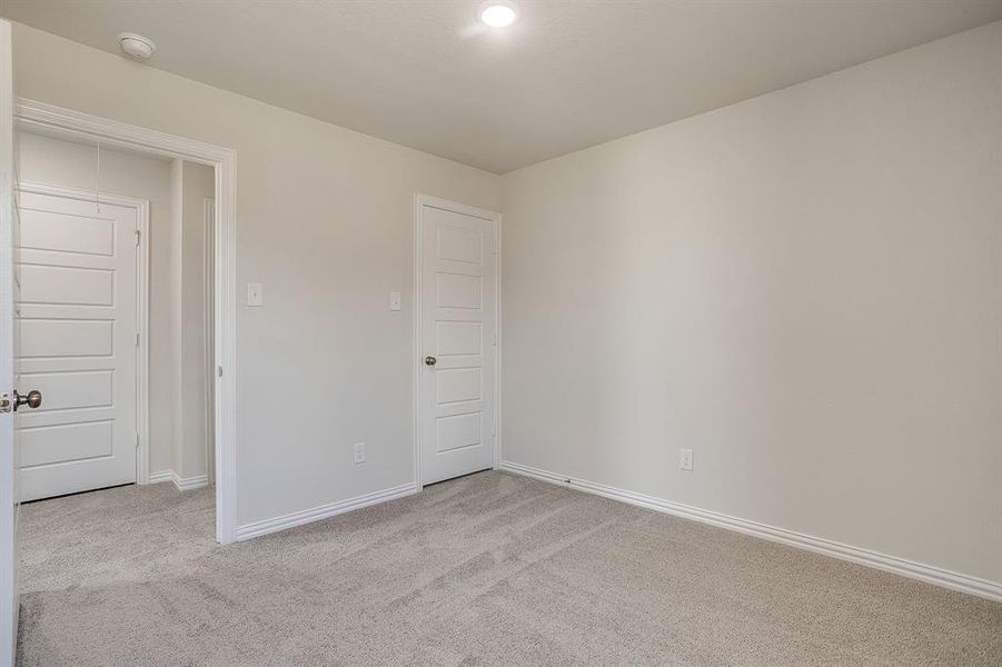 Unfurnished room with light carpet