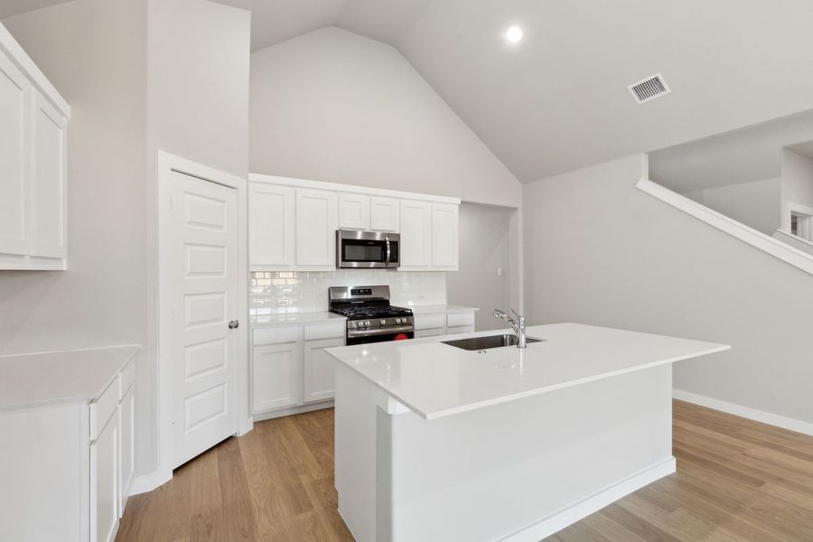 Kitchen in the Claret home plan by Trophy Signature Homes – REPRESENTATIVE PHOTO