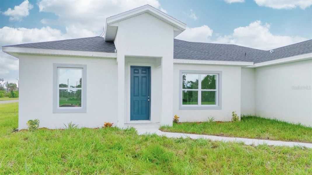 Front exterior of a new home in , Placida, FL, highlighting curb appeal (Image 27). Front exterior of a new home in , Placida, FL, highlighting curb appeal (Image 27).