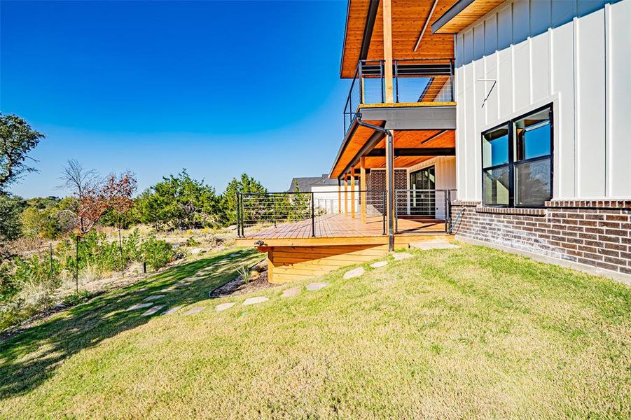 View of grassy yard featuring a deck View of grassy yard featuring a deck