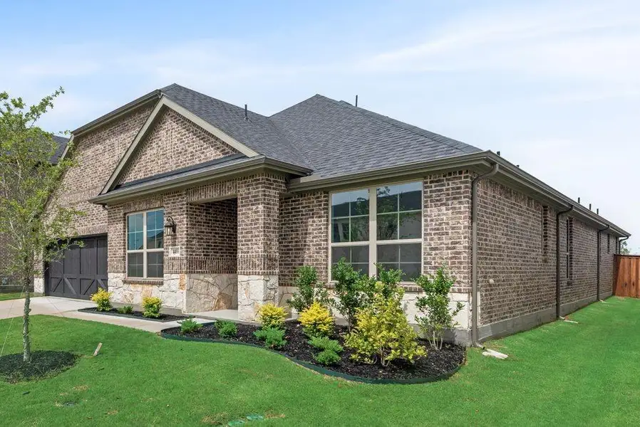 Front exterior of a new home in Sutton Fields, Celina, TX, highlighting curb appeal (Image 1). Front exterior of a new home in Sutton Fields, Celina, TX, highlighting curb appeal (Image 1).