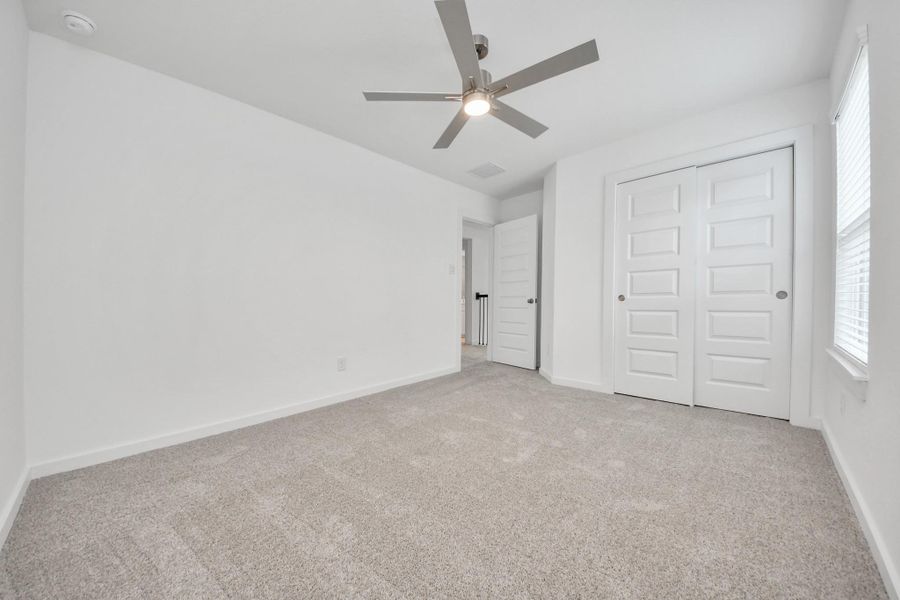 Generously sized secondary bedrooms featuring spacious closets, soft and inviting carpeting underfoot, large windows allowing plenty of natural light, and the added touch of privacy blinds for your personal retreat. Sample photo of completed home with similar floor plan. Actual colors and selections may vary. Generously sized secondary bedrooms featuring spacious closets, soft and inviting carpeting underfoot, large windows allowing plenty of natural light, and the added touch of privacy blinds for your personal retreat. Sample photo of completed home with similar floor plan. Actual colors and selections may vary.