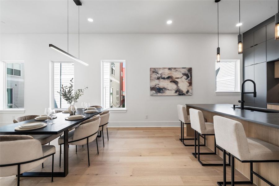 Unfolding beneath airy ceilings and grounded by pale engineered oak, the dining area is a seamless extension of the kitchen’s architectural rhythm. Defined by clean sightlines and natural light, this space invites both casual gatherings and elevated hosting. Whether it’s weekday takeout or a ten-person dinner party, the atmosphere remains effortlessly composed. Unfolding beneath airy ceilings and grounded by pale engineered oak, the dining area is a seamless extension of the kitchen’s architectural rhythm. Defined by clean sightlines and natural light, this space invites both casual gatherings and elevated hosting. Whether it’s weekday takeout or a ten-person dinner party, the atmosphere remains effortlessly composed.