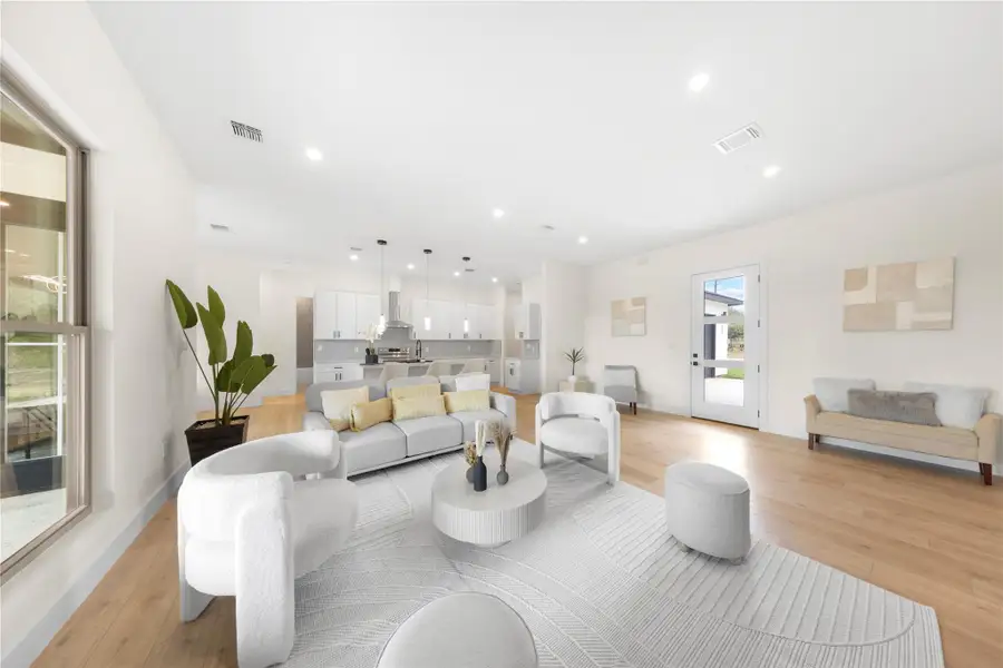 Living area with recessed lighting and light wood finished floors Living area with recessed lighting and light wood finished floors